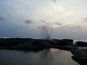 beach splashing water from rocks